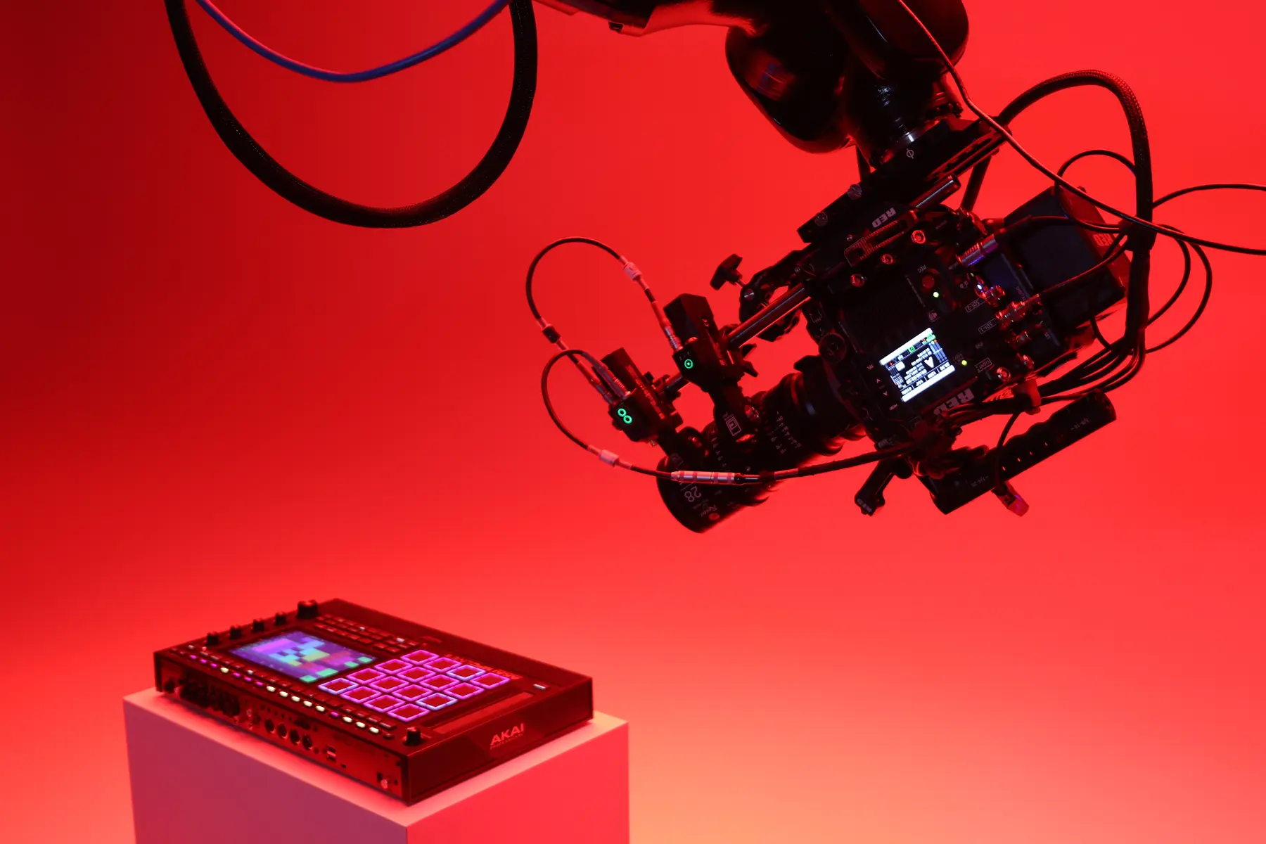 Cinema robot arm with camera over product in red lighting