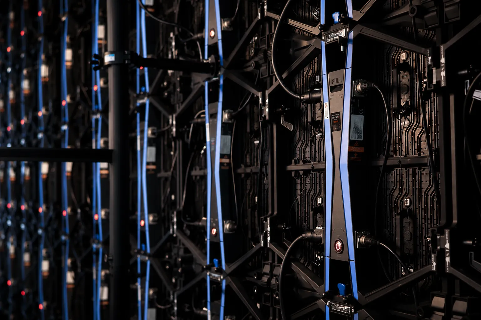 Behind the studio's LED volume, showing the display panels and cabling that drive in-camera virtual environments
