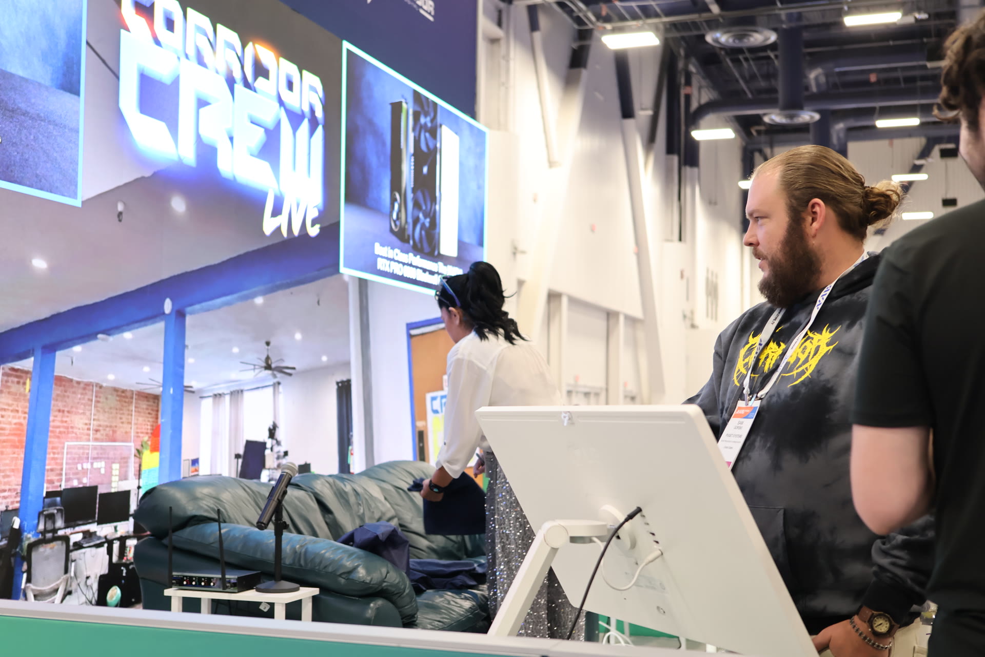Volumate driving a display at the Puget Systems booth, showing the Gaussian splat capture of Corridor's studio