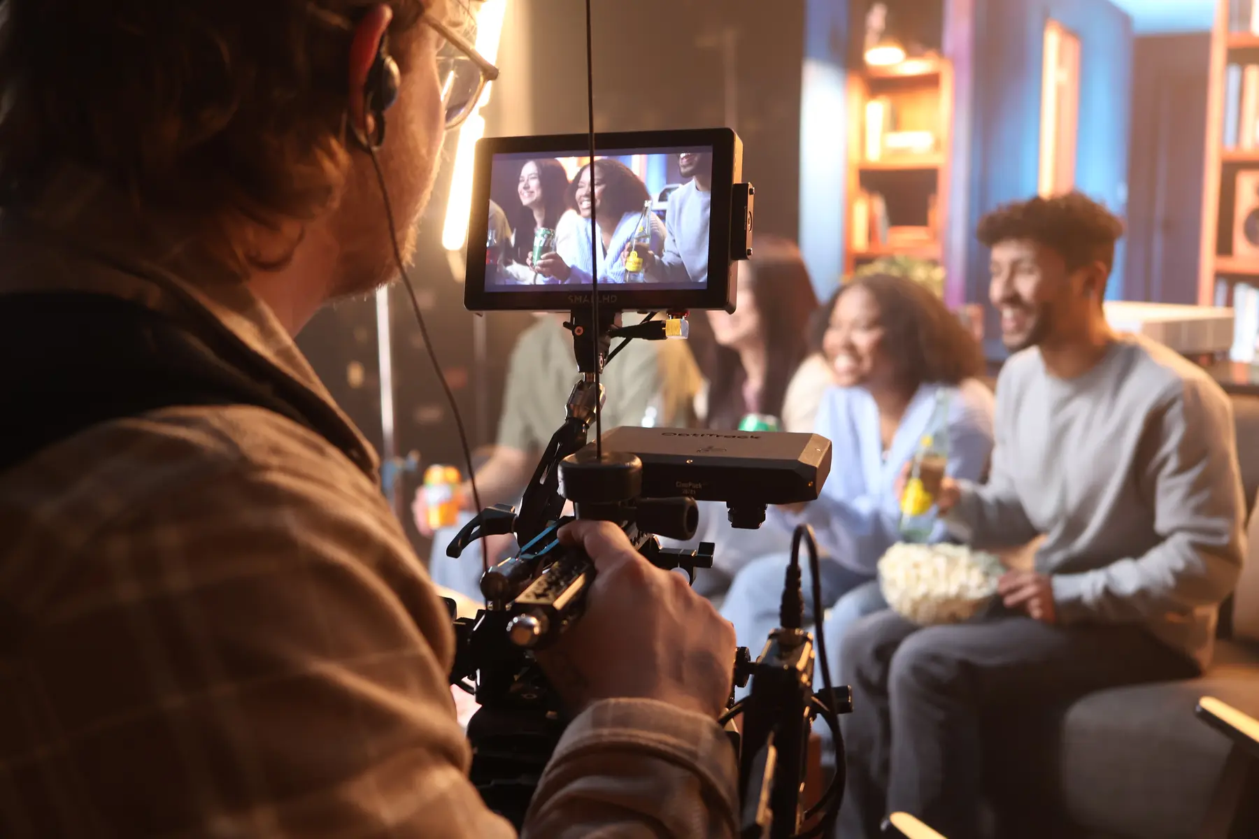 Camera operator filming talent with LED wall